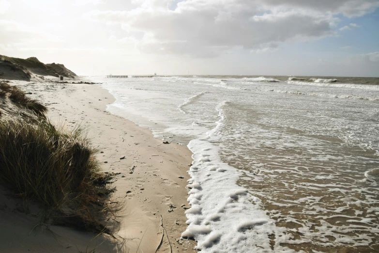 the waves roll in from the shore on a beach