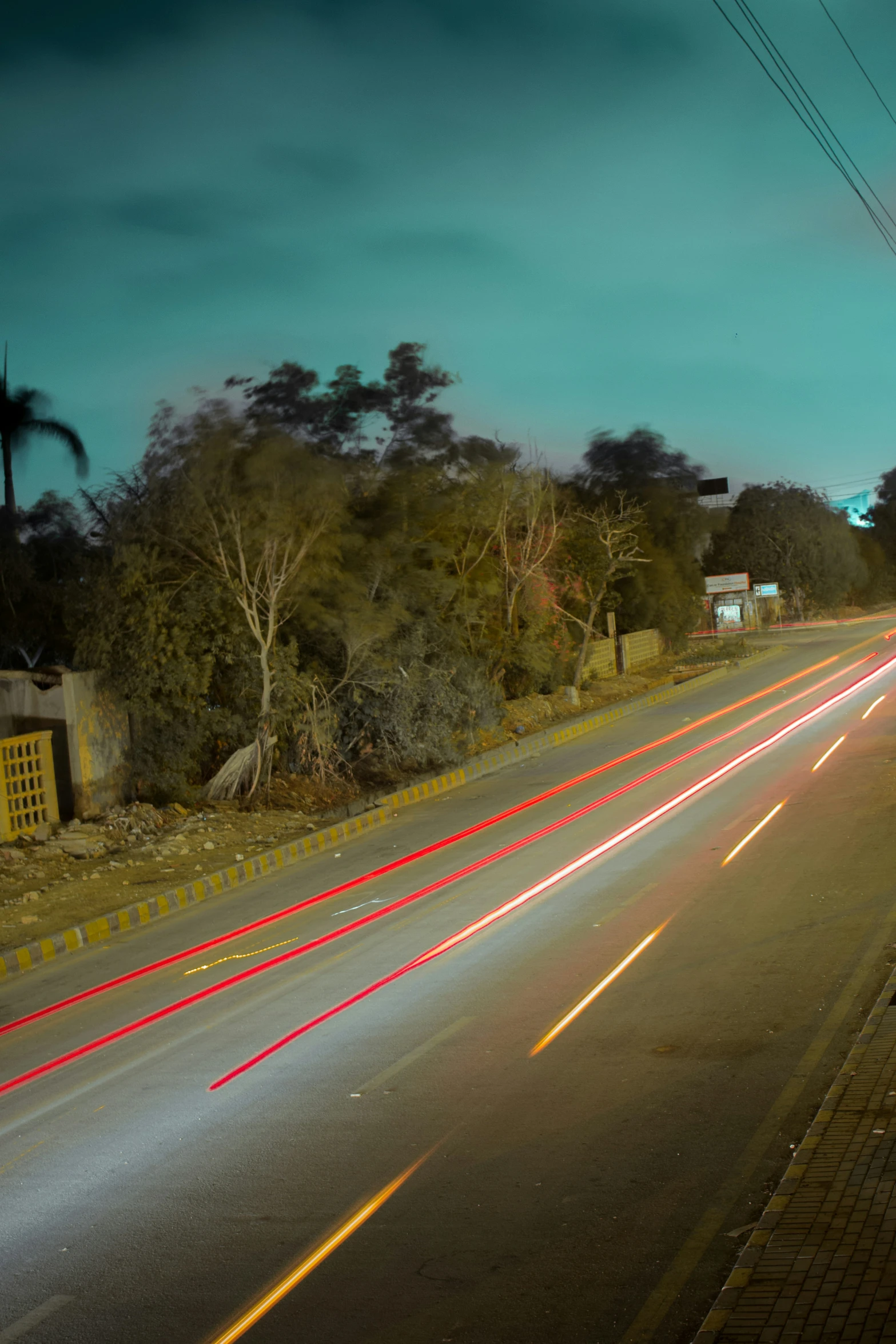 two cars on a empty road at night