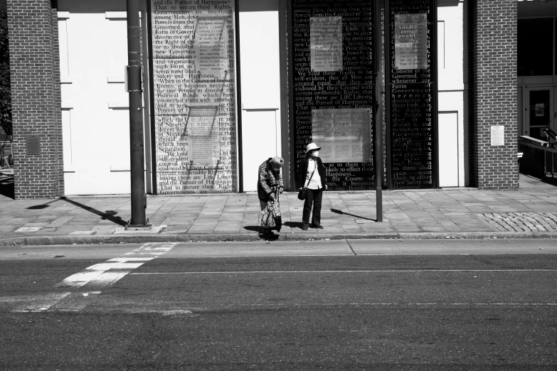 the person is waiting at a bus stop for their bus