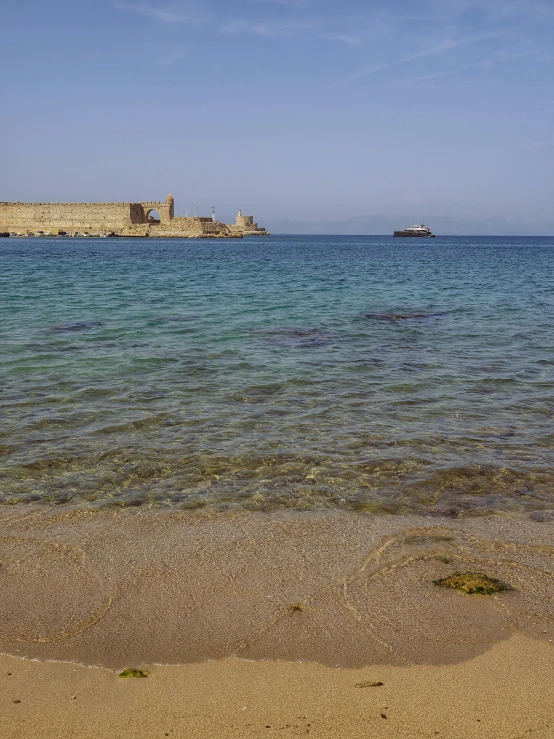 water is clean and calm as an object sits in the background