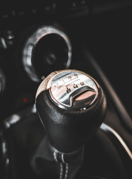 a car's dashboard with a control on and steering wheel