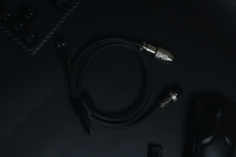 a pair of ear buds sits on a charger next to an open laptop