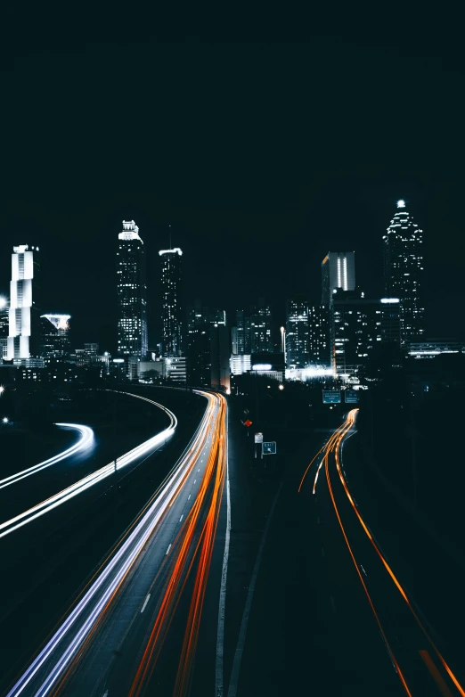 light trails lead up the side of a busy highway