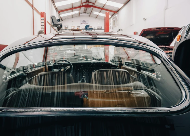 car parked in garage, reflection in rear window