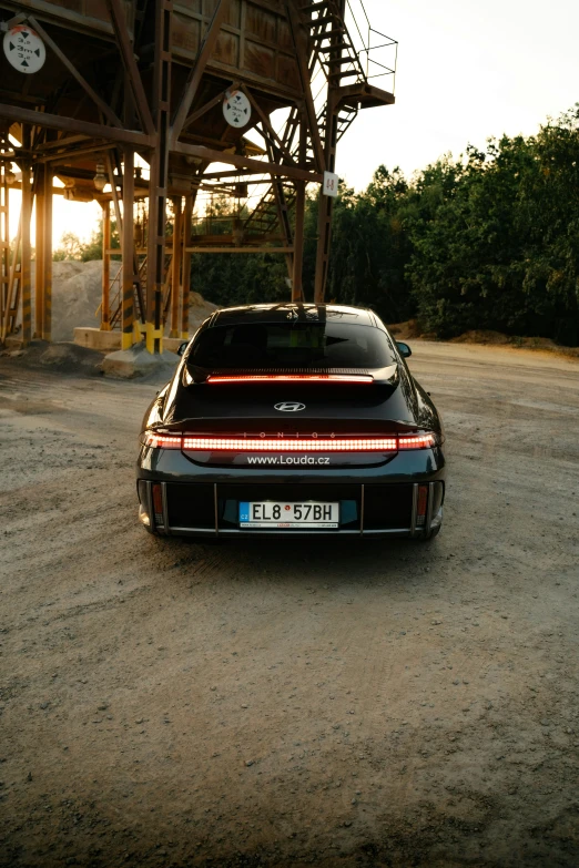 a sports car is in front of an overpass