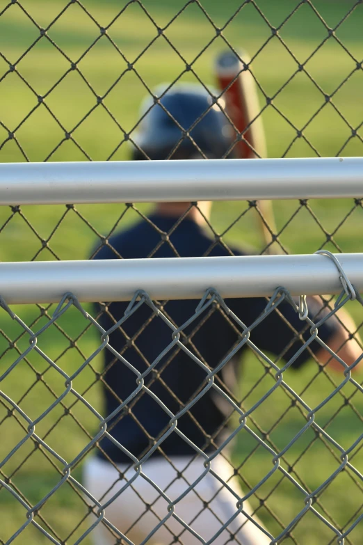 a  is playing baseball in a field