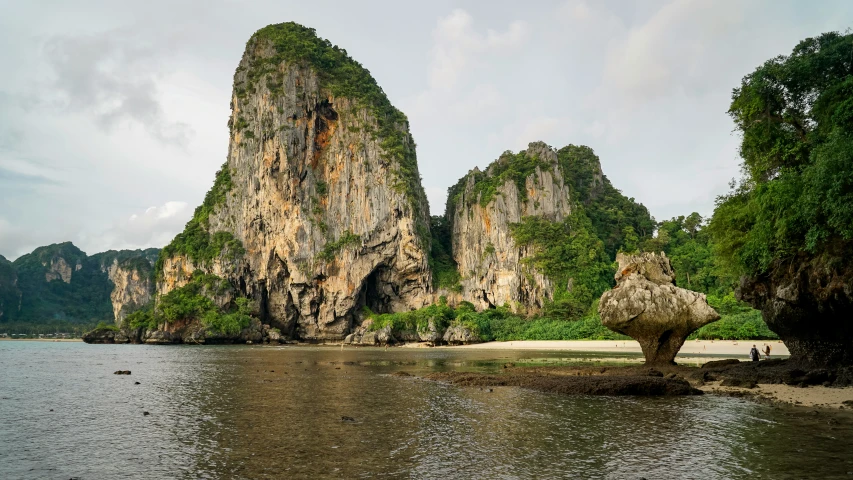 a small island on the shore with some rock formations