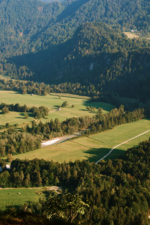 an aerial view of several green hills and valleys