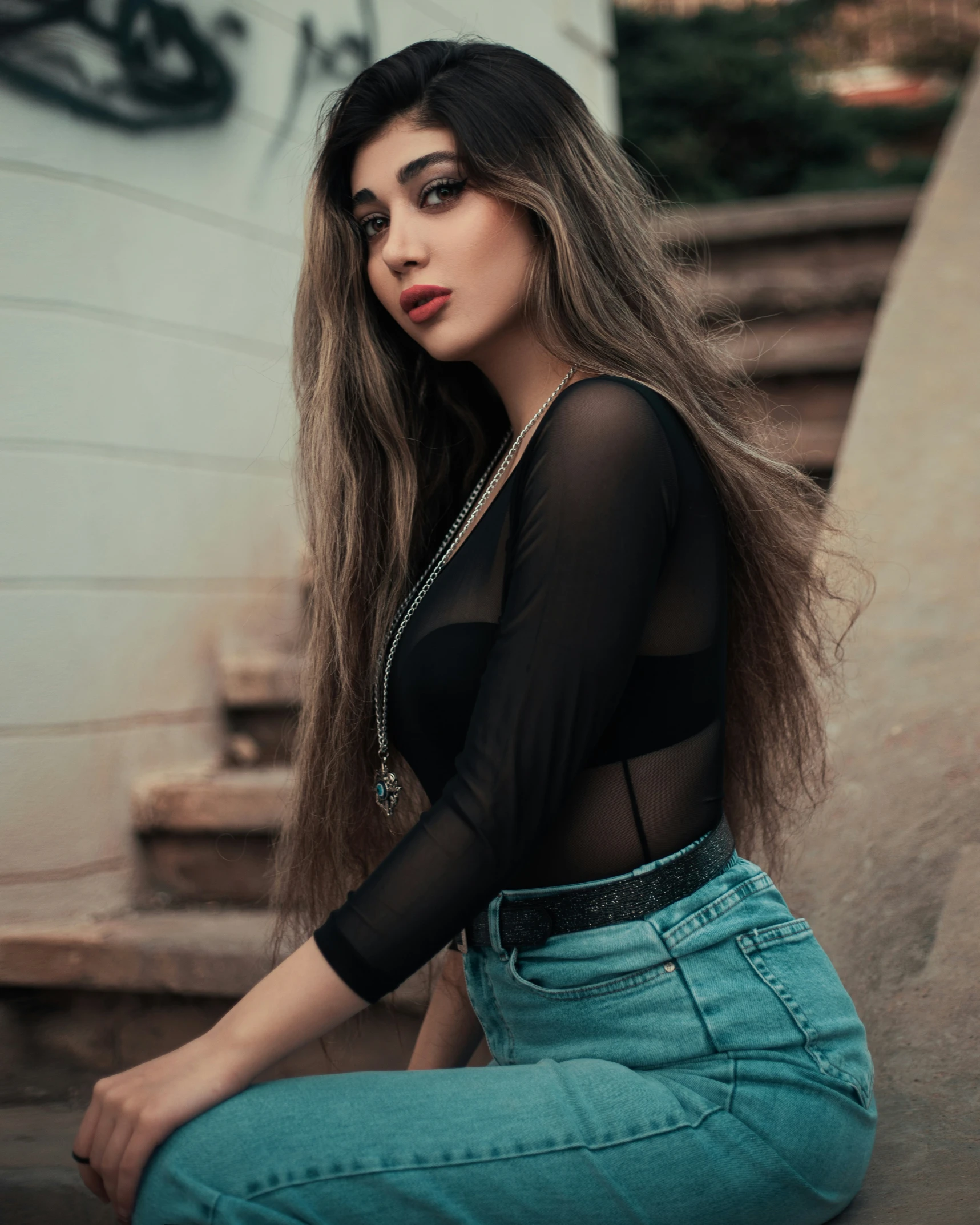 a woman in black top sitting on steps