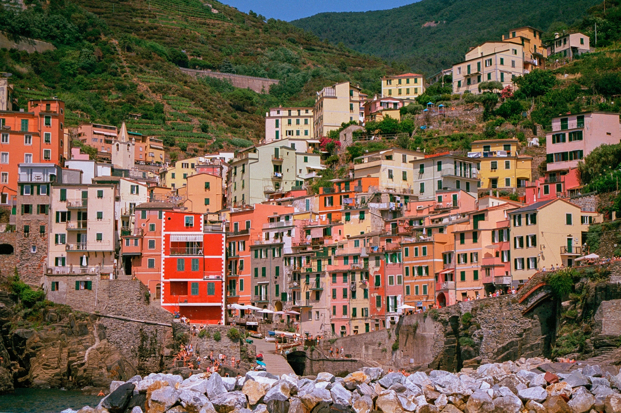 the top of a city surrounded by mountains and a body of water