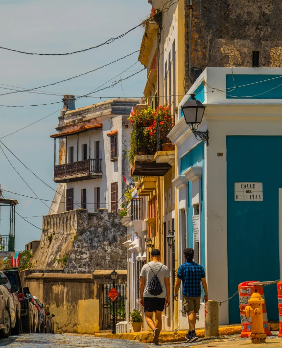 two people walking down the narrow street