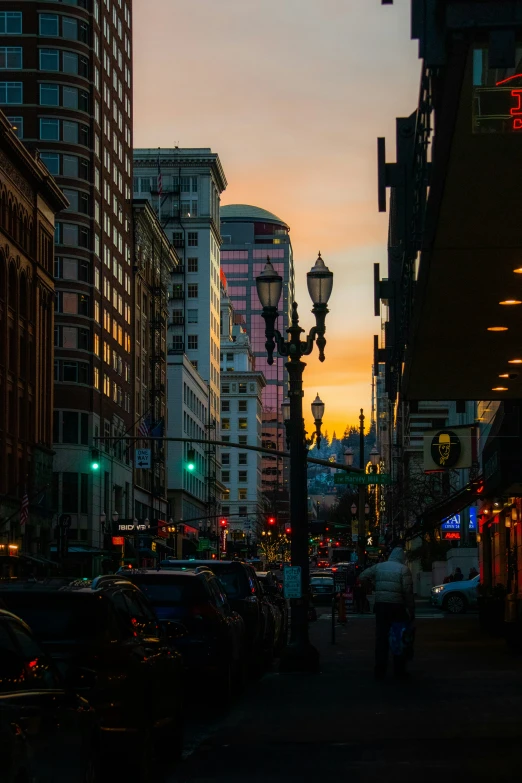 a street lined with tall buildings next to traffic