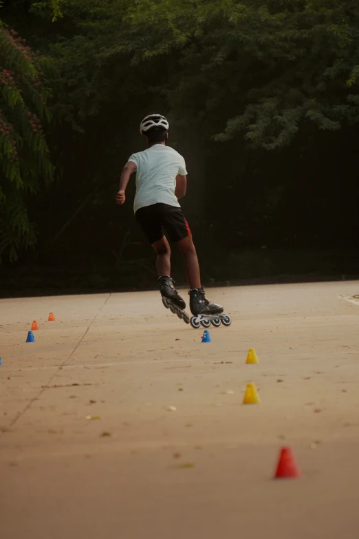 the skater is attempting a trick through some cones