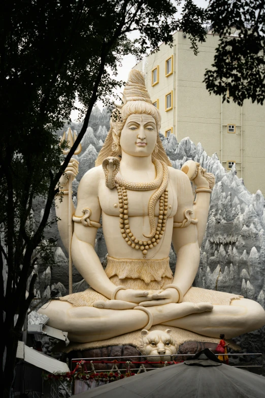 a statue of a seated indian person