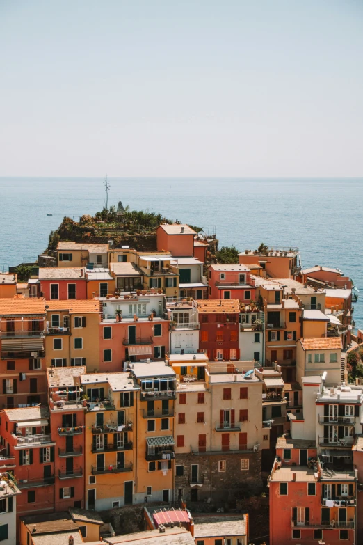 some houses sitting on the edge of a body of water