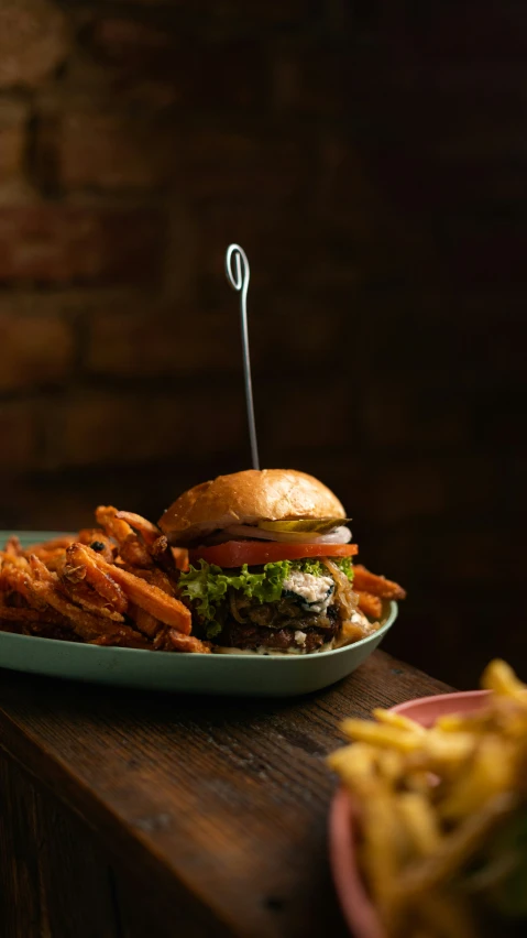 a plate of fries and a cheeseburger on a table