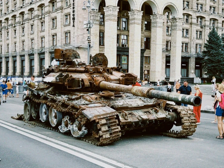 an old tank is sitting on the street