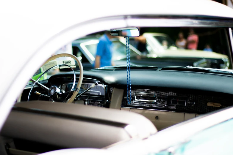 a car is reflected in a rear view mirror