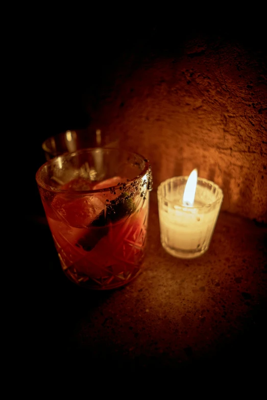 a lit candle sitting on top of a glass