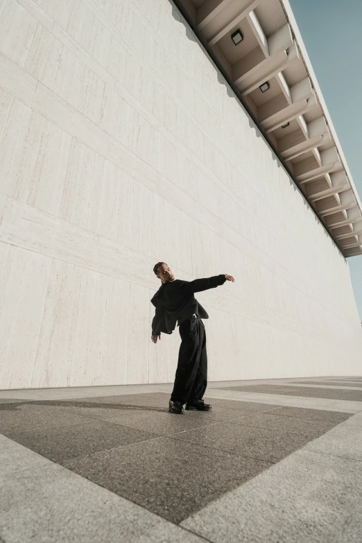 a man dressed in black practicing his karate