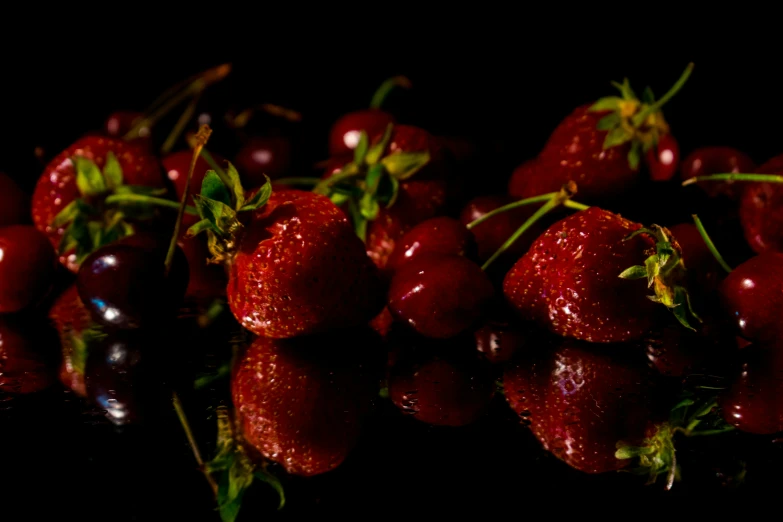 a bunch of strawberries is reflected on the surface