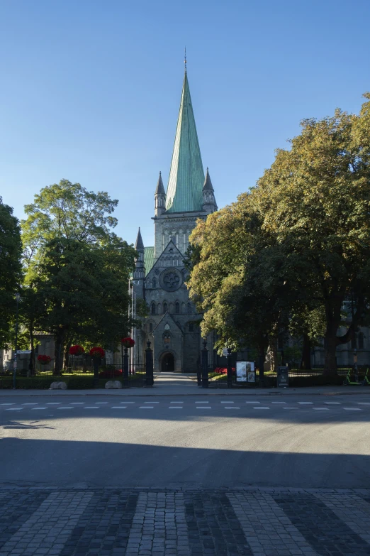 an old gothic style church with a steeple and tall spire