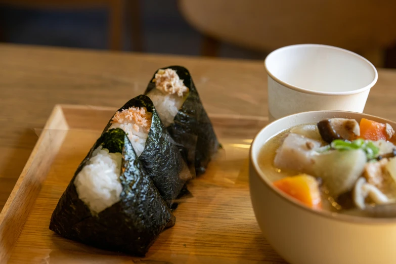 a bowl of soup and some sort of sushi