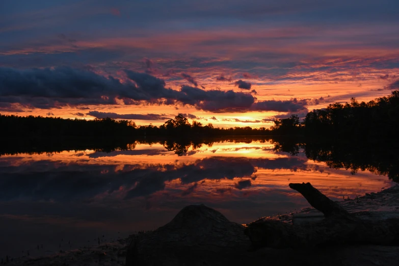 a bright sunset reflects the water and clouds