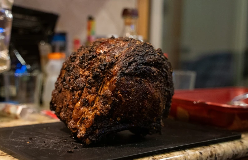 a cooked piece of meat sitting on top of a  board