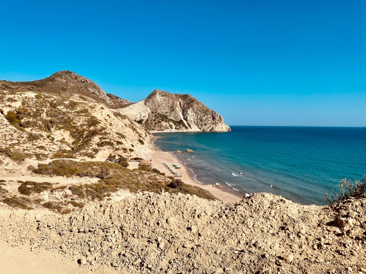 a rocky beach with people out at sea