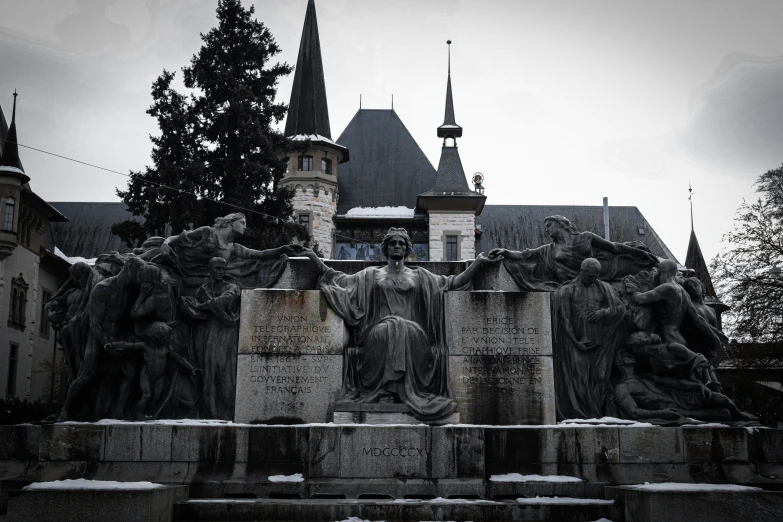 a large statue sits in front of the castle