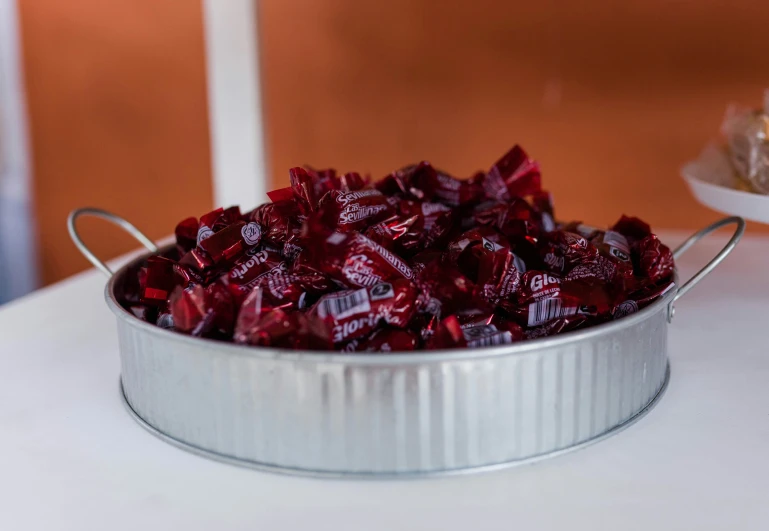 a bucket of crushed candy sitting on top of a counter