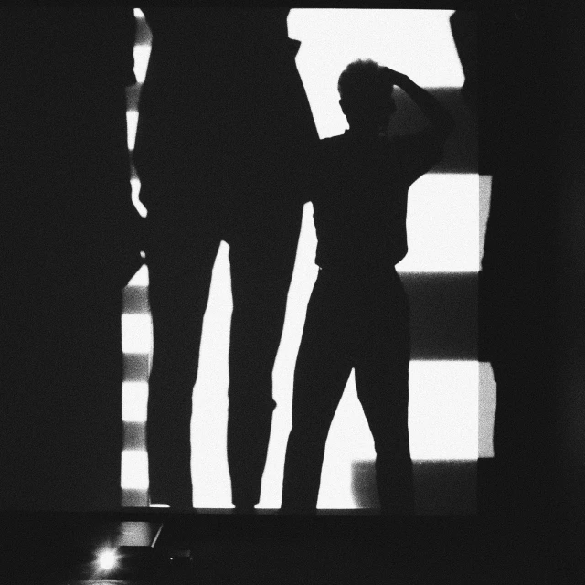 two people are standing in front of an open door