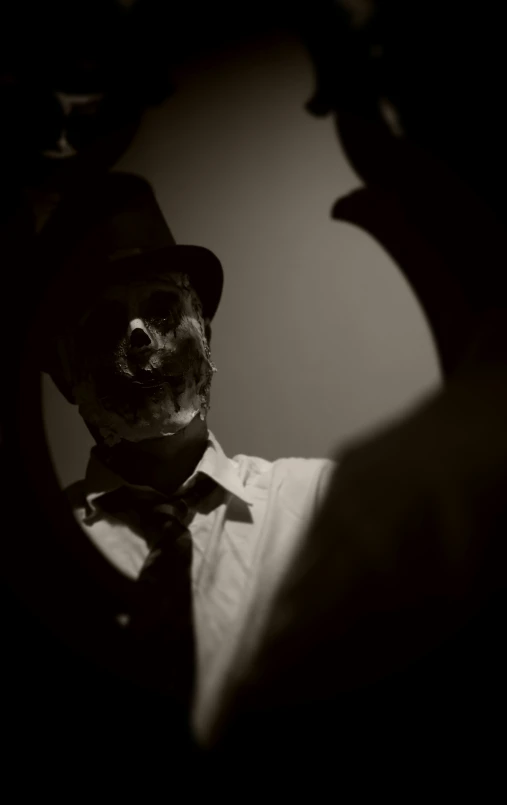 a skeleton wearing a hat and tie while taking a picture