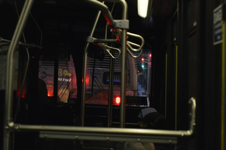 a group of people riding on a bus in the dark