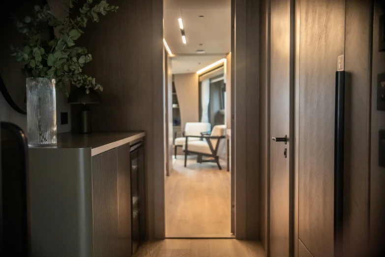 an empty hallway leading to a small sitting area