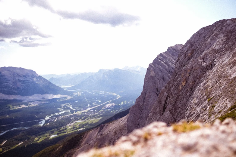 two people are on the mountain top looking out