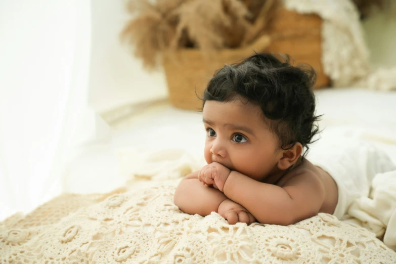 a baby on a bed with a teddy bear