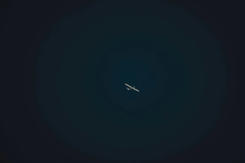 an airplane flying in the blue sky from high up