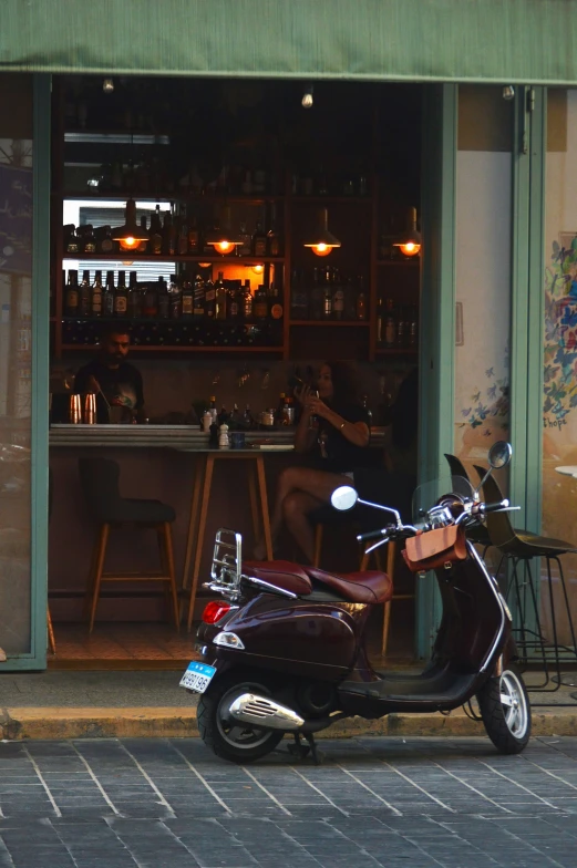 a motor bike parked in front of a restaurant