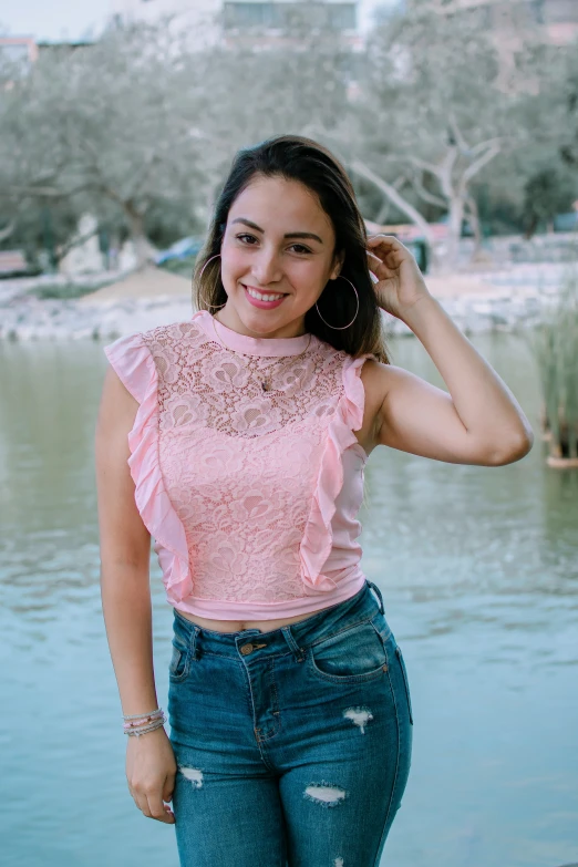 a girl posing for the camera wearing ripped jeans