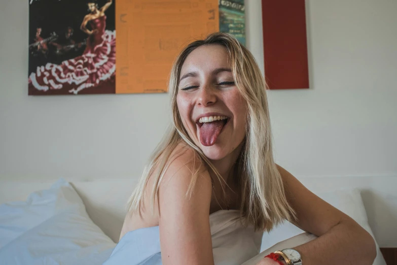 a girl making a silly face and smiling with her tongue out