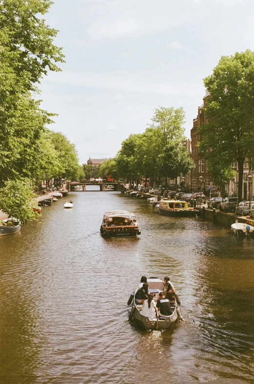 some boats on the water and people driving in them