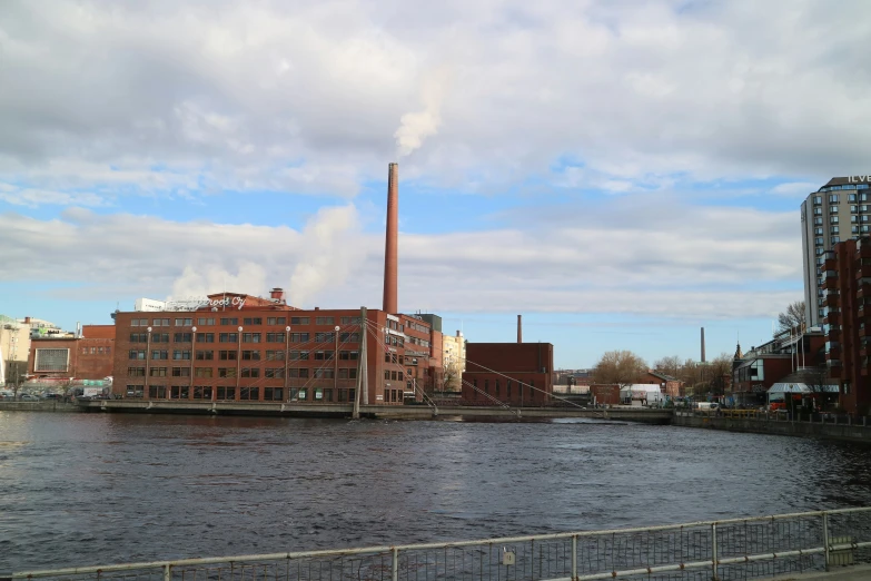 a factory is shown as seen from the water