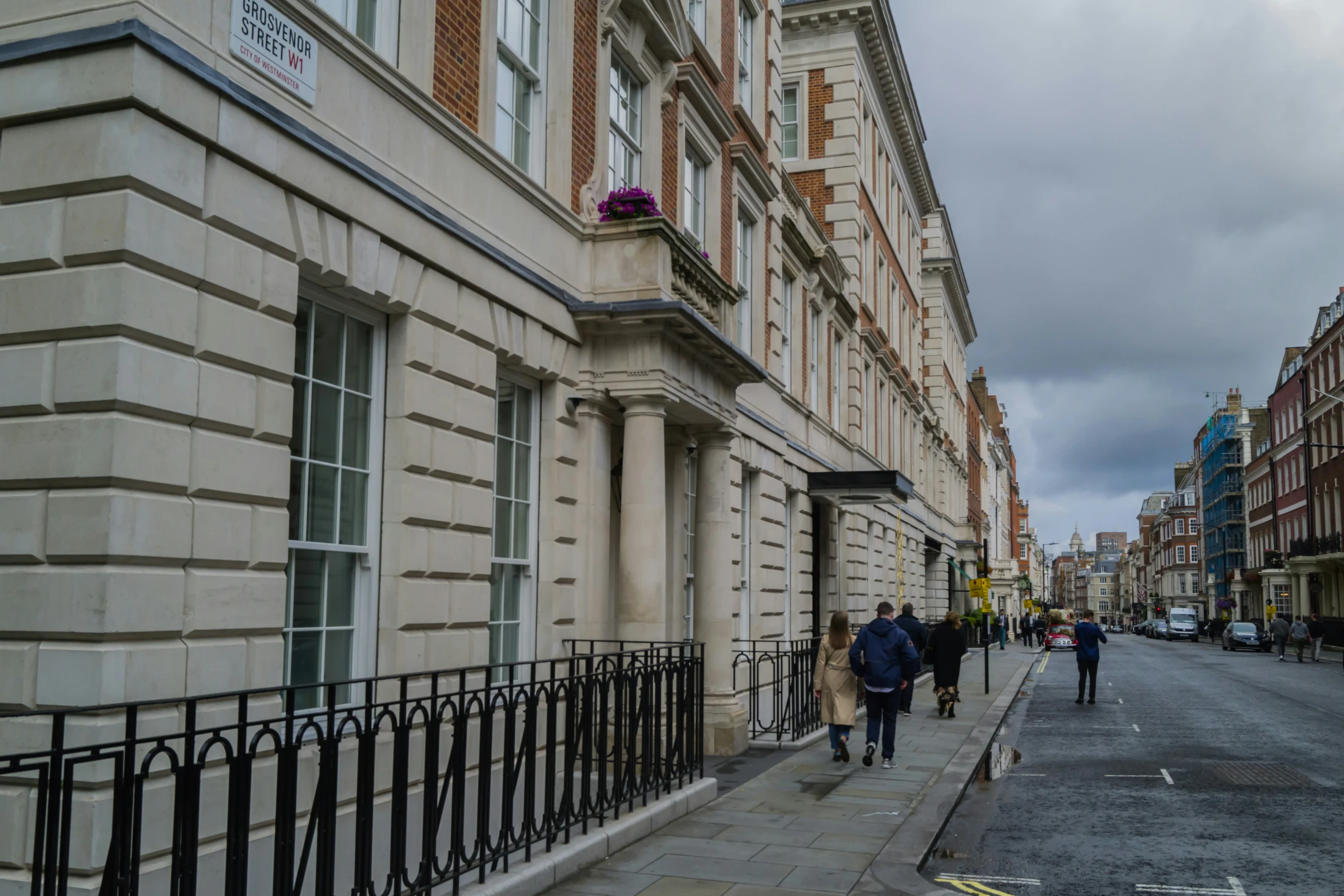 a street with buildings lined with people walking down it