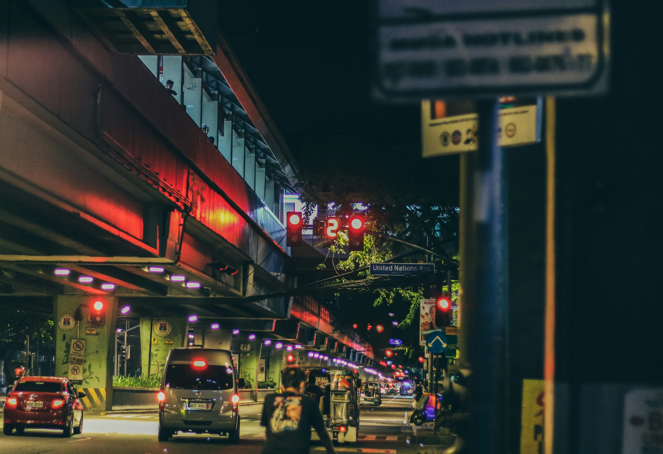 the lights are lit up and cars travel down the street