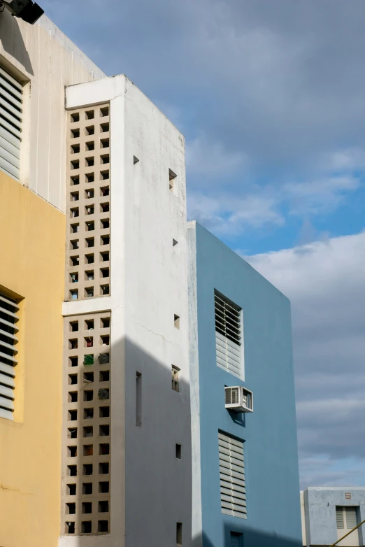 the back side of several different buildings with windows and shutters