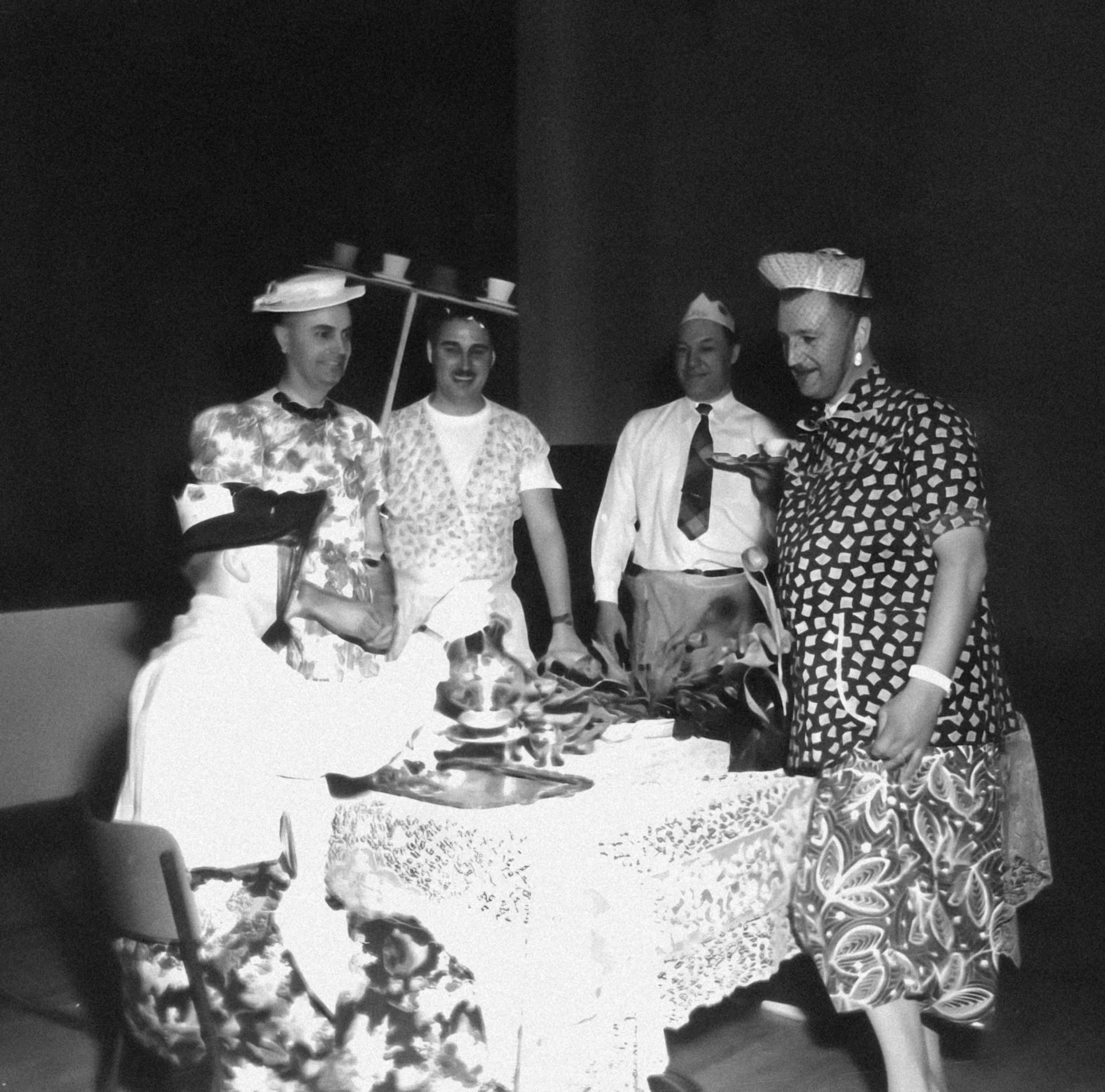 a group of people that are standing around a table