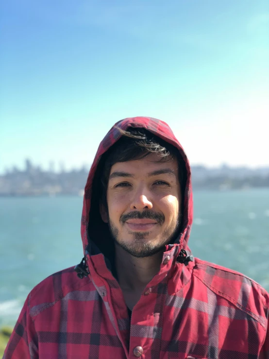 a man wearing a red and black plaid jacket