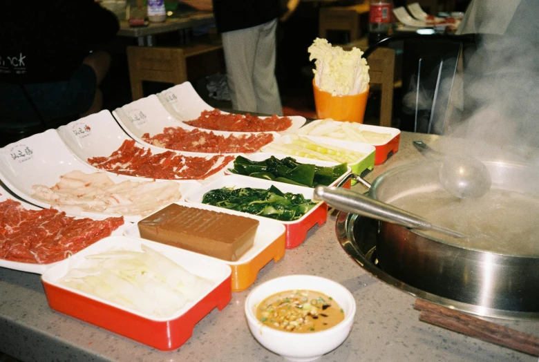 the countertop is covered with dishes of different foods